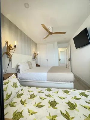a hotel room with two beds and a flat screen tv at Sobre el mar in Cullera