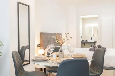 a dining room with a table and chairs at Suite Deluxe Valencia - Beach II Apartments in Valencia