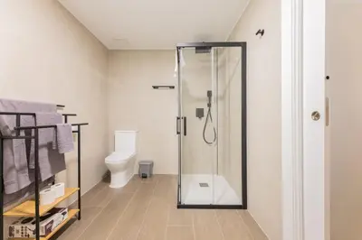 a bathroom with a shower and a toilet at Suite Deluxe Valencia - Beach II Apartments in Valencia
