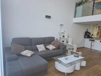 a living room with a couch and a table at Loft con jacuzzi y piscina in Valencia