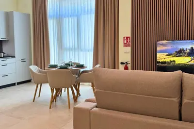 a living room with a table and a couch at Illetes Flats - Suite cerca de Feria de Muestras y Metro in Valencia