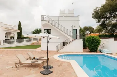 a villa with a swimming pool and a house at Spacious villa with private pool & garden for 4 in Partida de La Cañada