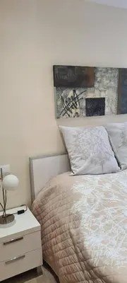 a bedroom with a bed and a nightstand with a white bedspread at Apartment Nules in Nules