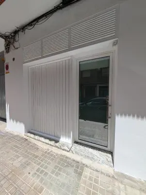 a garage with a sliding door on the side of a building at Apartamento Tucán in Valencia