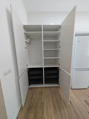 a closet with white cabinets and a refrigerator at Apartamento Tucán in Valencia