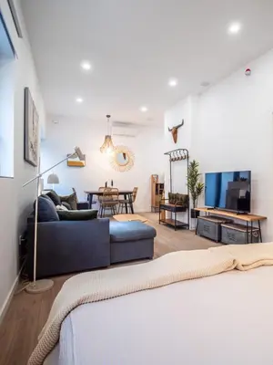a living room with a blue couch and a tv at Bonito loft para 4 personas in Valencia