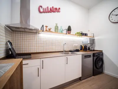 a kitchen with white cabinets and a sink at Bonito loft para 4 personas in Valencia