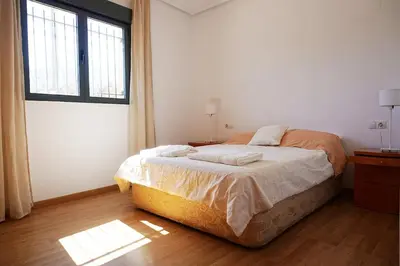 a bedroom with a bed and a window at PinyaLabs Sunrise Valencia, mer & montagne à 10min in Puebla de Farnals