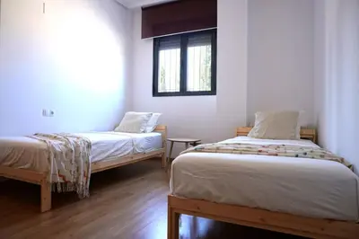 a room with two beds and a window at PinyaLabs Sunrise Valencia, mer & montagne à 10min in Puebla de Farnals