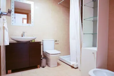 a bedroom with two beds and wooden cabinets at PinyaLabs Sunrise Valencia, mer & montagne à 10min in Puebla de Farnals