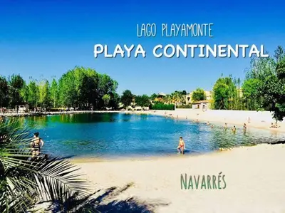two people playing in the water on a beach at Casa EL CRUCE Navarrés in Navarrés