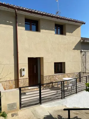 a house with a black fence in front of it at Casa EL CRUCE Navarrés in Navarrés