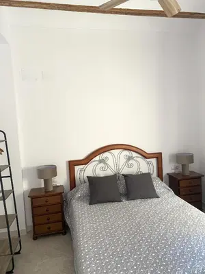 a bedroom with a bed with two night stands and two lamps at Casa EL CRUCE Navarrés in Navarrés