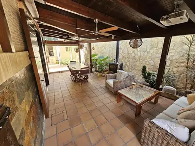 a living room with a couch and a table at Amazing Villa with swimming pool in Torrent