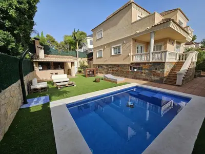 a house with a swimming pool in front of a house at Amazing Villa with swimming pool in Torrent