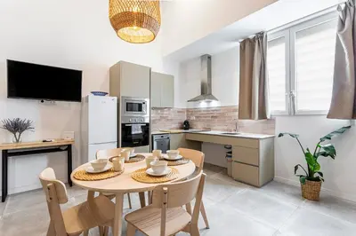 a kitchen with a table and chairs in a room at Lovely duplex on the beach in Valencia