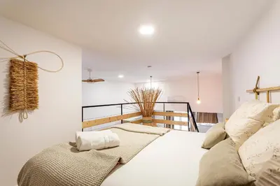 a bedroom with a white bed with pillows at Lovely duplex on the beach in Valencia