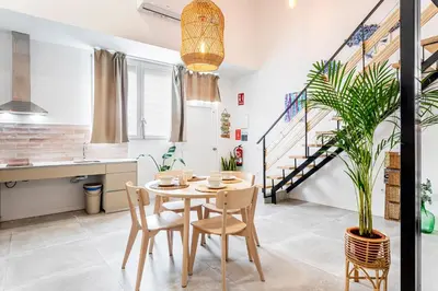 a kitchen and dining room with a table and chairs at Lovely duplex on the beach in Valencia