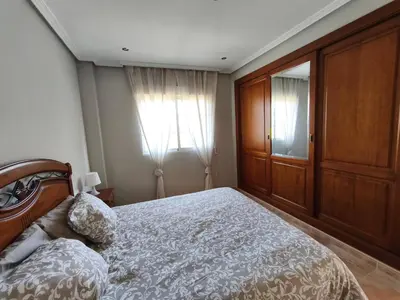 a bedroom with a large bed and a window at Villa Pepita in Torrent
