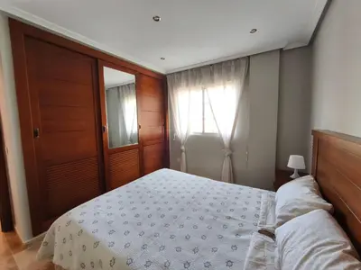 a bedroom with a large bed and a window at Villa Pepita in Torrent