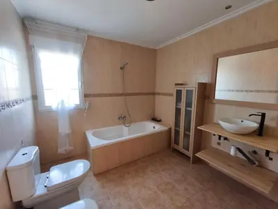 a bathroom with a tub and a toilet and a sink at Villa Pepita in Torrent