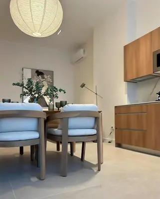 a dining room with a wooden table and chairs at Pivote Flats-Puerto C in Valencia