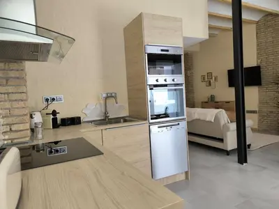 a kitchen with a refrigerator and a sink in a room at Apartment next to the Marina De Valencia in Valencia