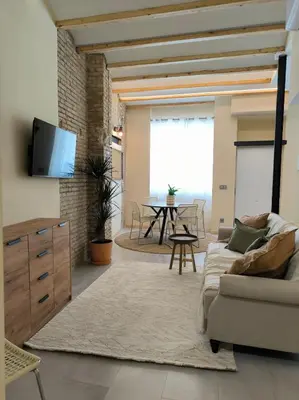 a living room with a couch and a table at Apartment next to the Marina De Valencia in Valencia