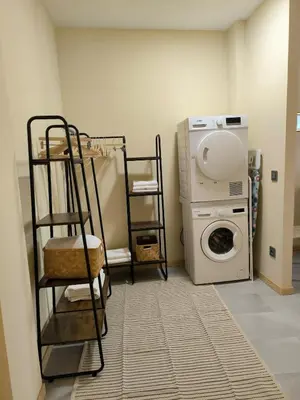 a laundry room with a washing machine and a washer at Apartment next to the Marina De Valencia in Valencia