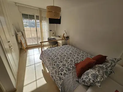 a bedroom with a bed and a desk and a window at Amazing Villa with swimming pool in El Vedat de Torrente in Torrent