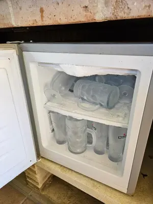 an open refrigerator filled with water bottles and cups at Amazing Villa with swimming pool in El Vedat de Torrente in Torrent