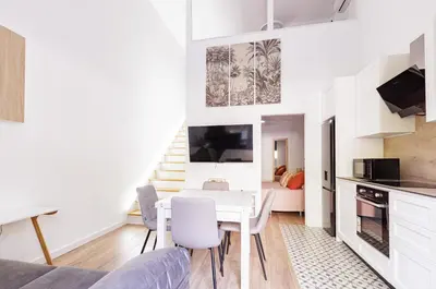 a kitchen and living room with a table and chairs at Urban apartment 4 BAJO - Housevanlive in Valencia