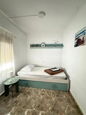a small room with a bed and a table at Apartamento edificio JUMAR in Cullera