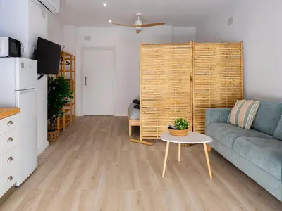a living room with a couch and a table at Boho Beach Flats in Valencia
