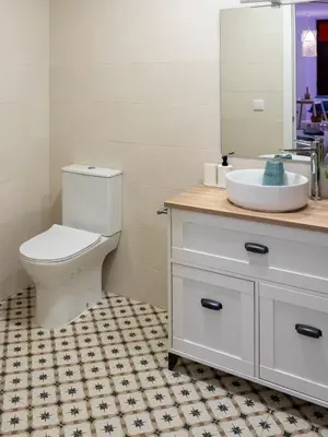 a bathroom with a white toilet and a sink at Boho Beach Flats in Valencia