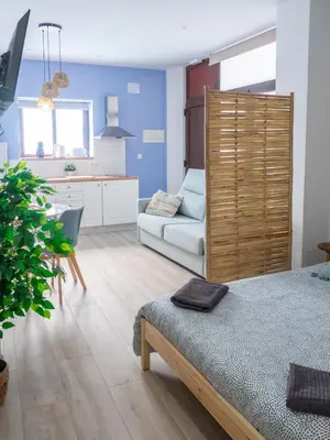 a living room with a bed and a couch at Boho Beach Flats in Valencia