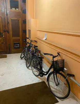 three bikes parked against a wall in a hallway at Bright, charming,in the historic center in Valencia