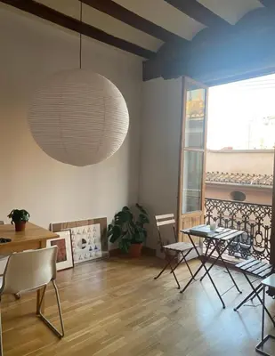 a dining room with a table and chairs and a pendant light at Bright, charming,in the historic center in Valencia