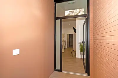 a hallway with a brick wall and a glass door at GuestReady - Lovely stay in the Algirós area in Valencia
