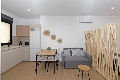 a living room with a couch and a table and a kitchen at GuestReady - Lovely stay in the Algirós area in Valencia