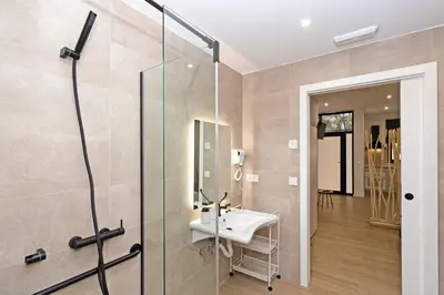 a bathroom with a sink and a glass shower at GuestReady - Lovely stay in the Algirós area in Valencia