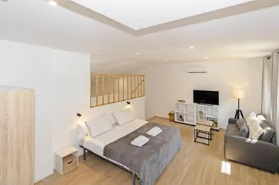 a bedroom with a bed and a couch and a tv at GuestReady - Beautiful loft in Valencia in Valencia
