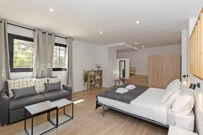 a bedroom with a large bed and a couch at GuestReady - Beautiful loft in Valencia in Valencia