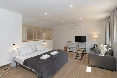a bedroom with a bed and a couch and a chair at GuestReady - Beautiful loft in Valencia in Valencia