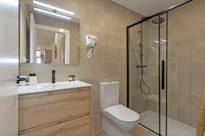 a bathroom with a shower and a toilet and a sink at GuestReady - Beautiful loft in Valencia in Valencia