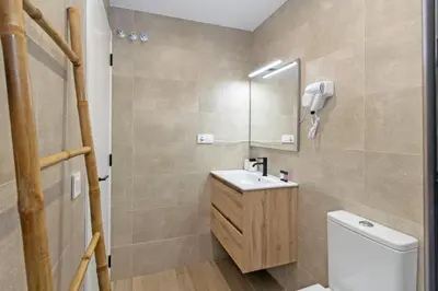 a bathroom with a toilet and a sink and a mirror at GuestReady - Beautiful loft in Valencia in Valencia