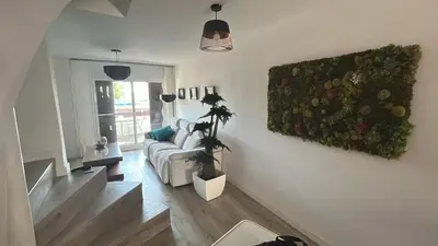 a living room with a couch and a painting on the wall at Tranquil Coastal Living in Puebla de Farnals