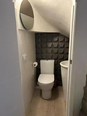 a small bathroom with a toilet and a mirror at Tranquil Coastal Living in Puebla de Farnals