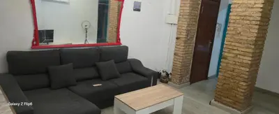 a living room with a couch and a mirror at Relax y bienestar in Valencia
