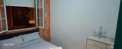 a small bedroom with a bed and a window at Relax y bienestar in Valencia